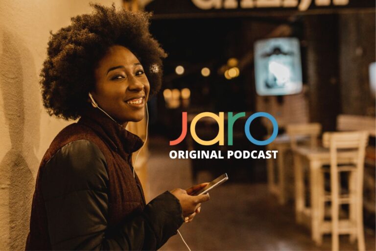 Smiling woman listening to earphones holding a phone with Jaro Original Podcast logo.